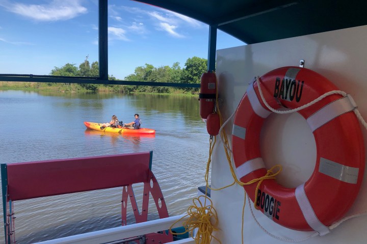 a boat sitting on top of a table next to a body of water