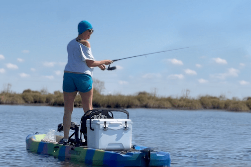 a person riding on the back of a boat in a body of water