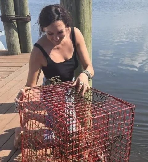 a woman standing in front of water