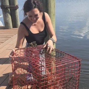 a woman standing in front of water