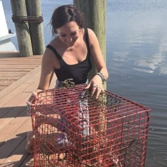 a woman standing in front of water